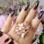 big beige butterfly ring on finger