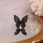 black butterfly ring on table