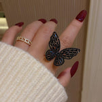 black butterfly ring on finger