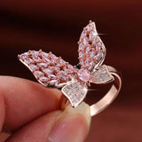 blinged out butterfly pink ring on hand