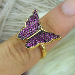 gold and purple butterfly ring on finger