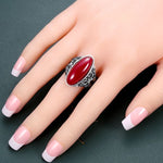 red coral butterfly ring on finger